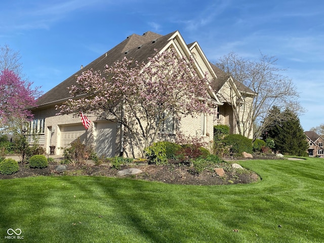 11967 Windpointe Pass, Carmel, IN 46033 - view of home's exterior with brick siding and a yard