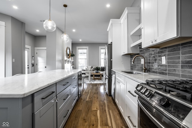 1665 N College Ave, Indianapolis, IN 46202 - kitchen featuring a sink, stainless steel appliances, gray cabinetry, open shelves, and dark wood finished floors