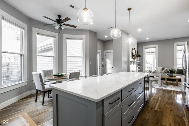 1665 N College Ave, Indianapolis, IN 46202 - kitchen with gray cabinetry, plenty of natural light, a kitchen island, ceiling fan, and recessed lighting