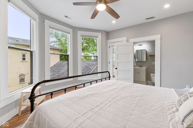 1665 N College Ave, Indianapolis, IN 46202 - bedroom with wood finished floors, a sink, connected bathroom, recessed lighting, and baseboards