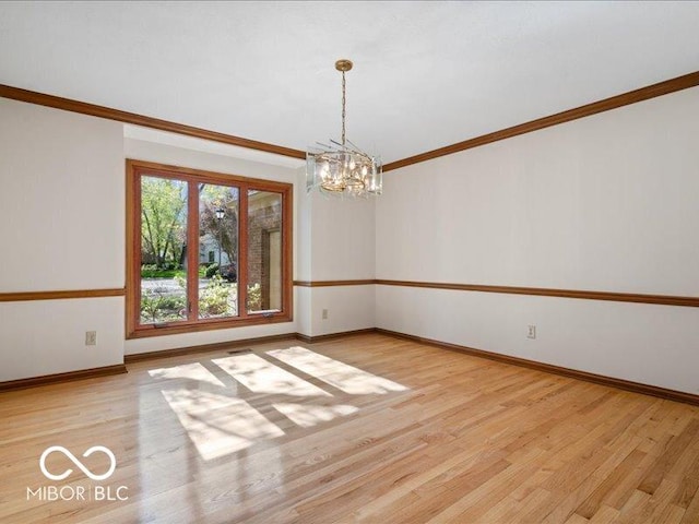 empty room with crown molding, baseboards, light wood-style flooring, and a chandelier