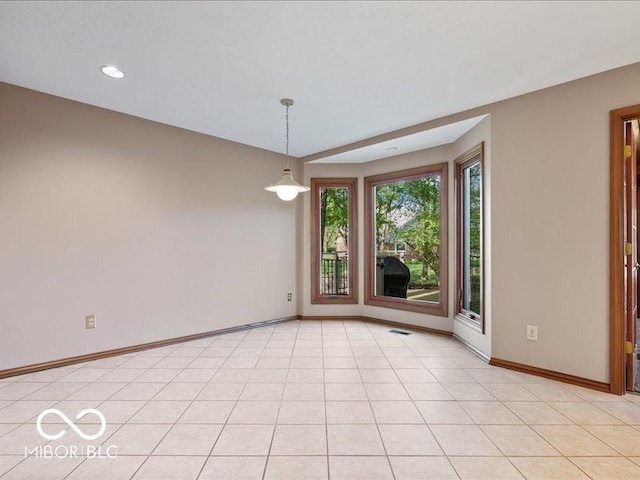 spare room featuring baseboards, recessed lighting, and visible vents