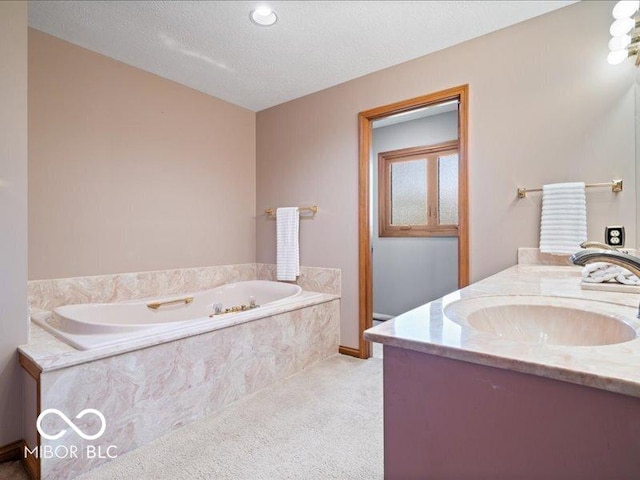 bathroom with a sink, double vanity, a textured ceiling, baseboards, and a garden tub