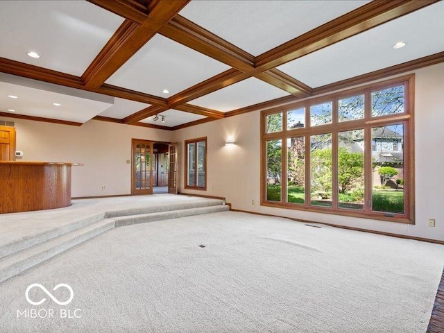unfurnished living room featuring baseboards, ornamental molding, and coffered ceiling