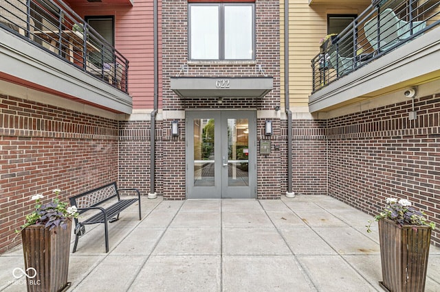 622 E 10th St Unit 206, Indianapolis, IN 46202 - doorway to property with french doors, brick siding, and a patio