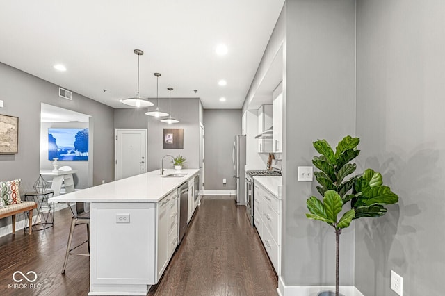 622 E 10th St Unit 206, Indianapolis, IN 46202 - kitchen featuring appliances with stainless steel finishes, a sink, light countertops, dark wood-type flooring, and recessed lighting