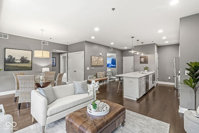 622 E 10th St Unit 206, Indianapolis, IN 46202 - living area with baseboards, recessed lighting, and dark wood-style flooring