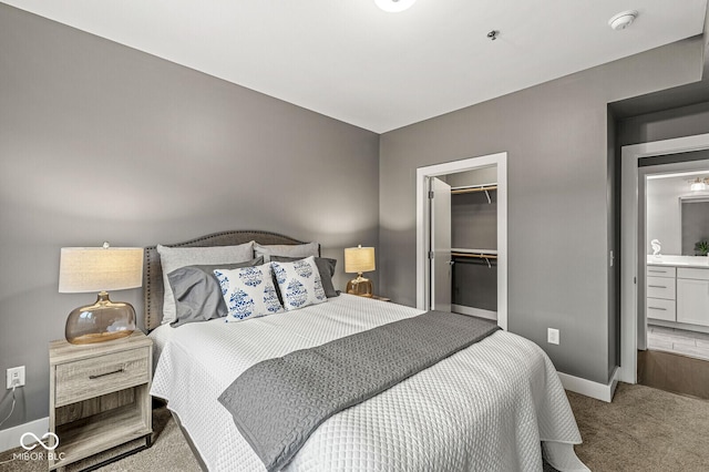 622 E 10th St Unit 206, Indianapolis, IN 46202 - carpeted bedroom featuring baseboards, a spacious closet, and a closet