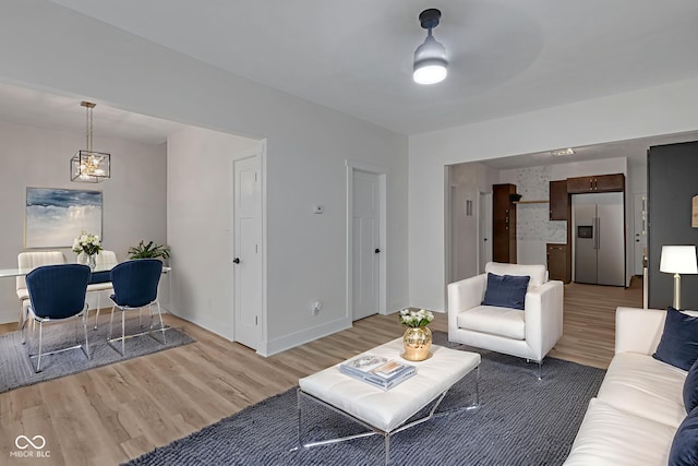 843 N Oxford St, Indianapolis, IN 46201 - living area with a chandelier and light wood-type flooring