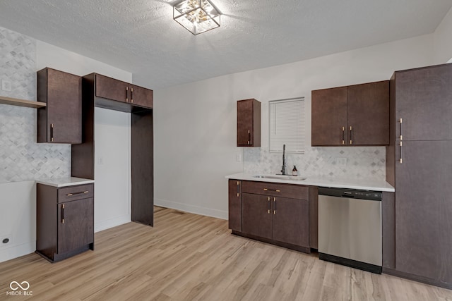 843 N Oxford St, Indianapolis, IN 46201 - kitchen with stainless steel dishwasher, light wood finished floors, light countertops, and a textured ceiling