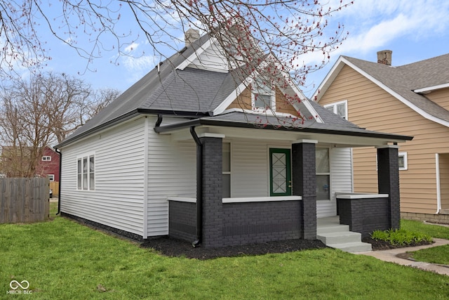 843 N Oxford St, Indianapolis, IN 46201 - view of front facade featuring a porch, brick siding, and a shingled roof