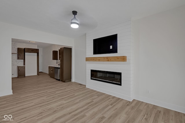 843 N Oxford St, Indianapolis, IN 46201 - unfurnished living room with light wood-style floors and a large fireplace