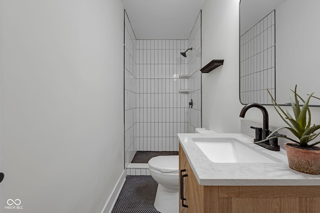 843 N Oxford St, Indianapolis, IN 46201 - bathroom featuring vanity, tiled shower, and tile patterned flooring