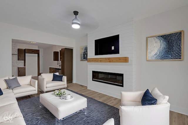 843 N Oxford St, Indianapolis, IN 46201 - living area featuring light wood finished floors and a fireplace