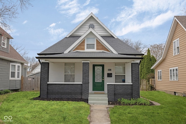 843 N Oxford St, Indianapolis, IN 46201 - view of front of house featuring a porch, brick siding, and a shingled roof