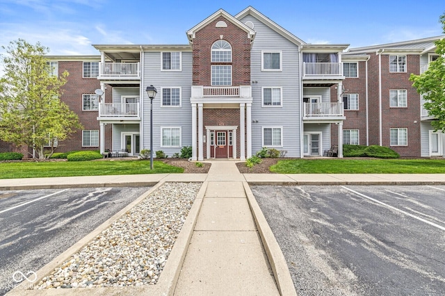 6231 Amber Creek Ln Unit 312, Indianapolis, IN 46237 - view of front of property featuring uncovered parking and brick siding