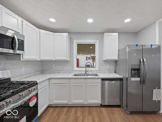 329 Roosevelt Dr, Shelbyville, IN 46176 - kitchen with dark wood finished floors, white cabinetry, appliances with stainless steel finishes, and a sink