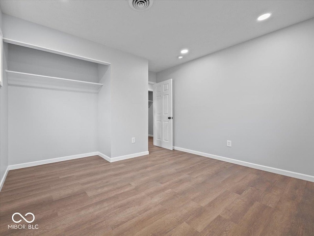 329 Roosevelt Dr, Shelbyville, IN 46176 - unfurnished bedroom with visible vents, wood finished floors, recessed lighting, a closet, and baseboards