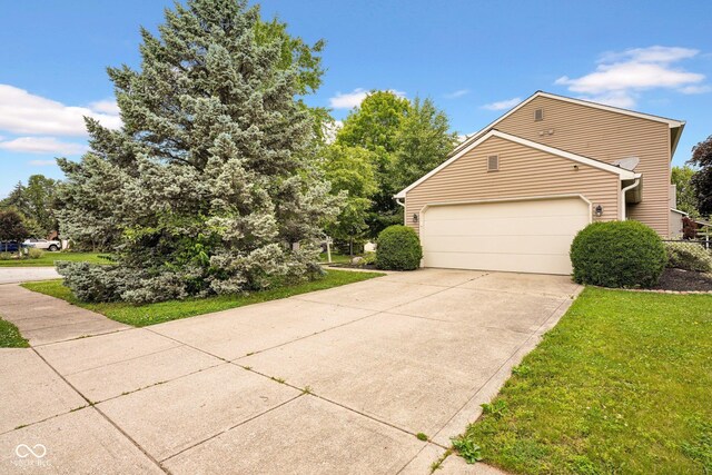 7383 Poppyseed Dr, Indianapolis, IN 46237 - view of property exterior with a garage, driveway, and a lawn