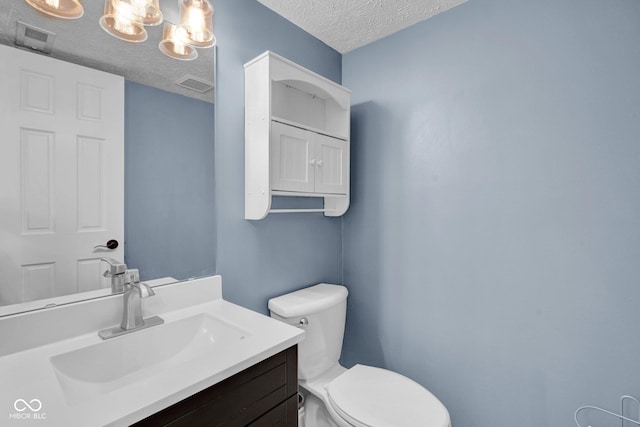 7383 Poppyseed Dr, Indianapolis, IN 46237 - bathroom with toilet, vanity, and a textured ceiling