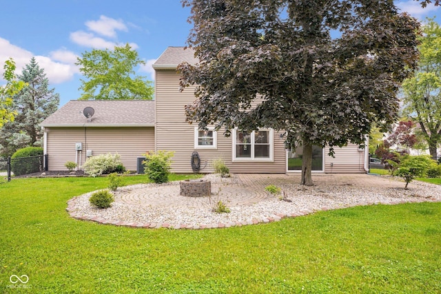 7383 Poppyseed Dr, Indianapolis, IN 46237 - rear view of property with a patio, roof with shingles, central air condition unit, and an outdoor fire pit