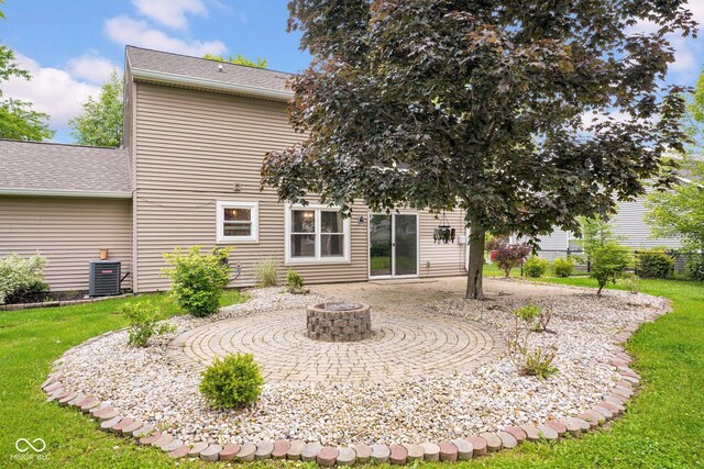 7383 Poppyseed Dr, Indianapolis, IN 46237 - rear view of property featuring a yard, central AC, an outdoor fire pit, a patio, and roof with shingles
