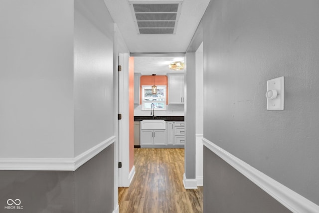 7383 Poppyseed Dr, Indianapolis, IN 46237 - hall with wood finished floors, baseboards, and a sink