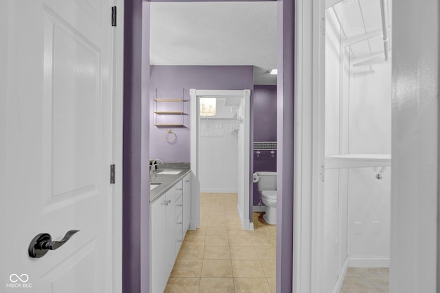 7383 Poppyseed Dr, Indianapolis, IN 46237 - bathroom with toilet, tile patterned flooring, vanity, a closet, and a textured ceiling
