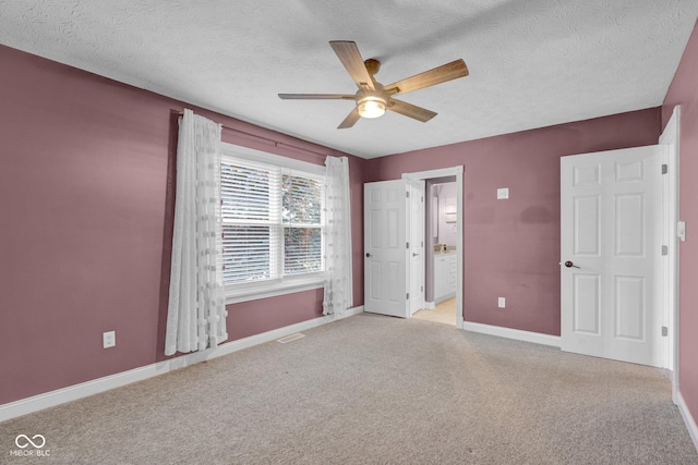 7383 Poppyseed Dr, Indianapolis, IN 46237 - unfurnished bedroom featuring light colored carpet, baseboards, a textured ceiling, ensuite bathroom, and ceiling fan