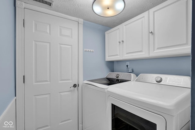 7383 Poppyseed Dr, Indianapolis, IN 46237 - laundry room with independent washer and dryer, cabinet space, and a textured ceiling