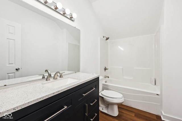 full bathroom featuring toilet, wood finished floors, vanity, and shower / bathing tub combination