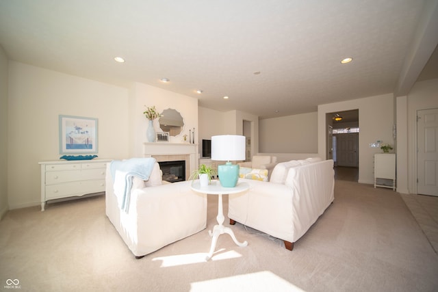 living area with recessed lighting, baseboards, light carpet, and a tile fireplace
