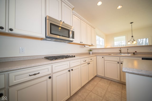 kitchen with recessed lighting, light countertops, a sink, hanging light fixtures, and stainless steel appliances