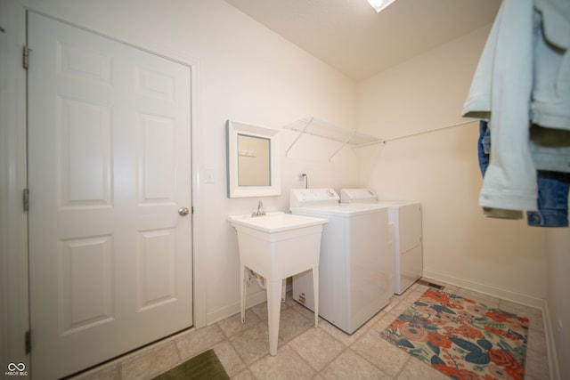laundry room with separate washer and dryer, baseboards, and laundry area