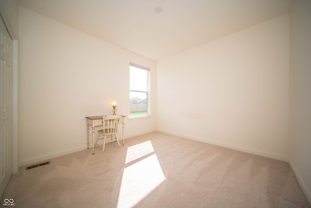 unfurnished room with baseboards, carpet flooring, and visible vents