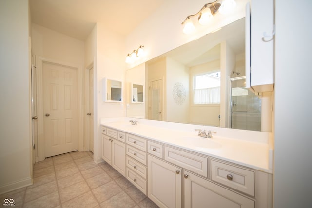 bathroom featuring double vanity, a sink, and a shower with door