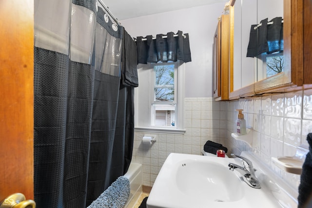bathroom with a sink and tile walls