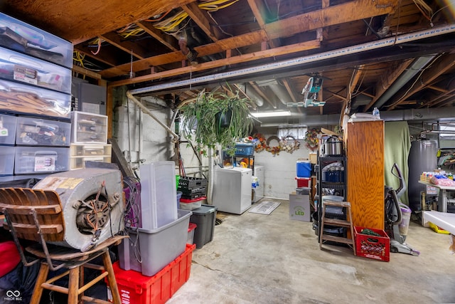 unfinished below grade area featuring separate washer and dryer and water heater