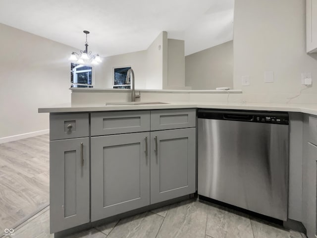 kitchen with gray cabinets, a notable chandelier, a sink, dishwasher, and a peninsula
