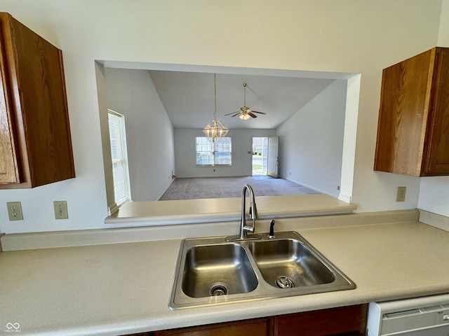 kitchen featuring a sink, light countertops, dishwashing machine, lofted ceiling, and ceiling fan