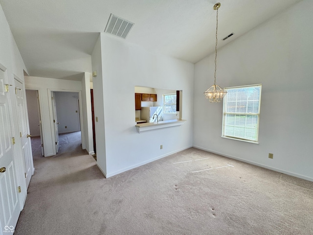 interior space with visible vents, light carpet, a notable chandelier, and baseboards