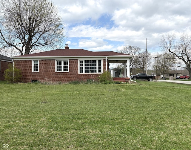5368 Southeastern Ave, Indianapolis, IN 46203 - view of front of property with a chimney, a front lawn, and brick siding