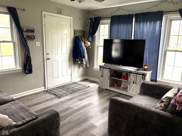5368 Southeastern Ave, Indianapolis, IN 46203 - living room with a textured ceiling, wood finished floors, ceiling fan, and baseboards