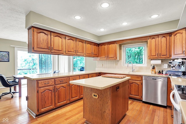 22 Point Ln, Arcadia, IN 46030 - kitchen featuring stainless steel dishwasher, a textured ceiling, a peninsula, white range, and brown cabinetry