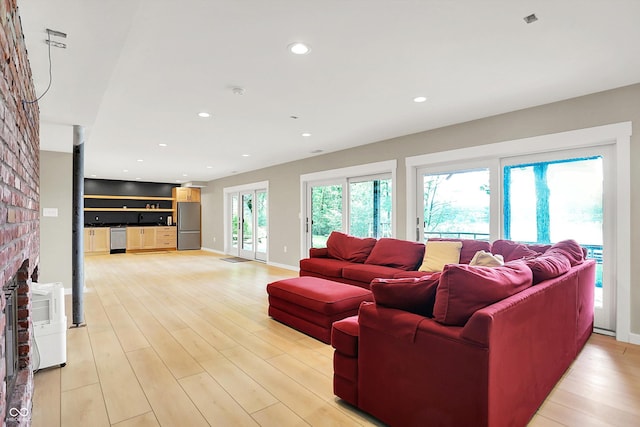 22 Point Ln, Arcadia, IN 46030 - living area with light wood-type flooring, a brick fireplace, and recessed lighting