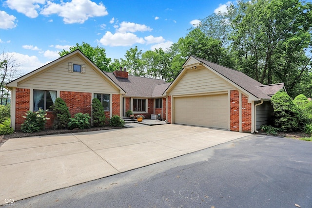 22 Point Ln, Arcadia, IN 46030 - view of front of property featuring an attached garage, a chimney, brick siding, concrete driveway, and roof with shingles