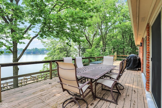 22 Point Ln, Arcadia, IN 46030 - wooden deck featuring a water view, outdoor dining area, area for grilling, and view of scattered trees