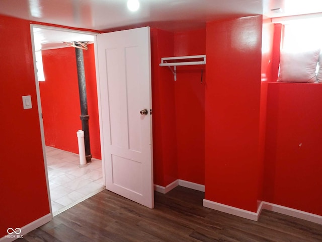 unfurnished bedroom featuring baseboards and wood finished floors