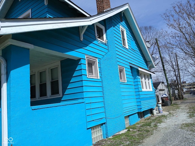 view of property exterior featuring a chimney