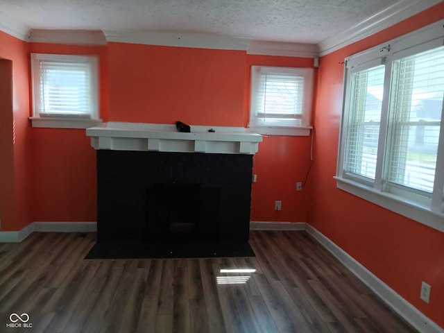 living area with a fireplace with flush hearth, baseboards, wood finished floors, and a textured ceiling
